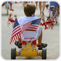 boy riding bicycle in 4th of July parade