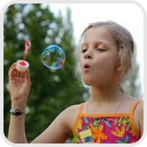 girl blowing bubbles