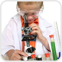 boy looking into a microscope